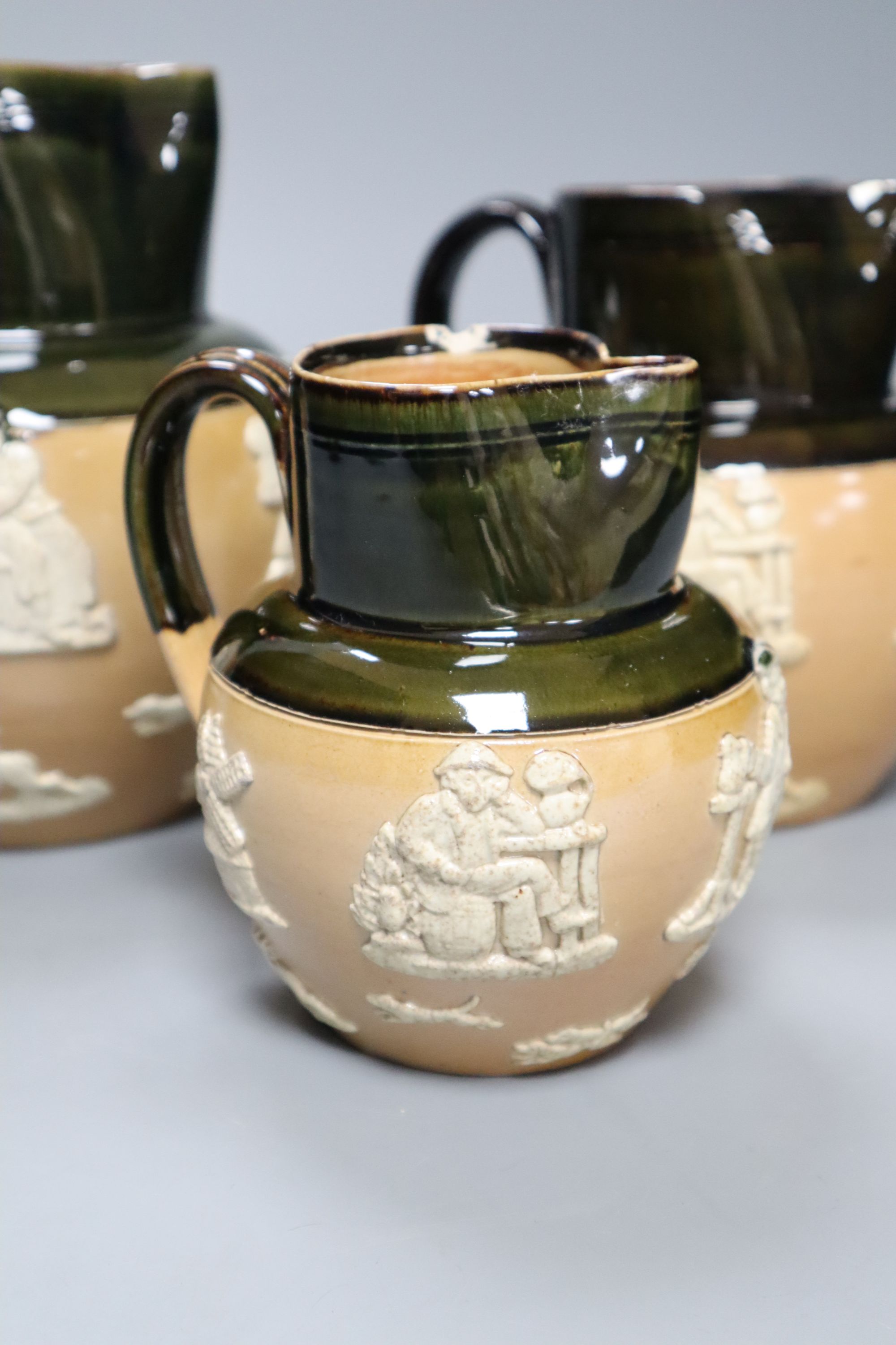 A graduated set of three Victorian Royal Doulton earthenware harvest jugs, tallest 19cm